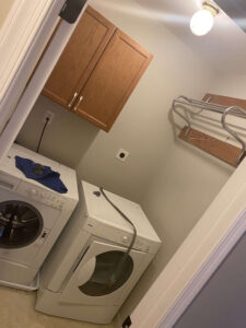 This is what our laundry room looked like originally. A 15-year-old set of a washer & dryer and some ugly cabinets.