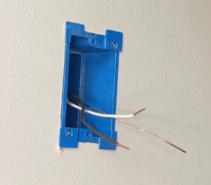 Showing how the wires look once they are exposed to wire the new outlet.