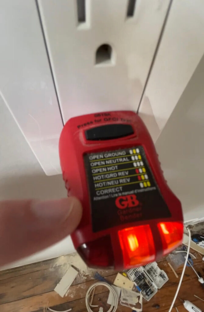 Outlet tester with two lights in the middle and right - signifying that I wired the outlet correctly.